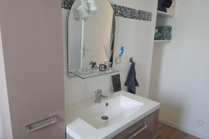 a bathroom with a white sink and a mirror at Spacious and cosy 80 m house located in Séné in Séné
