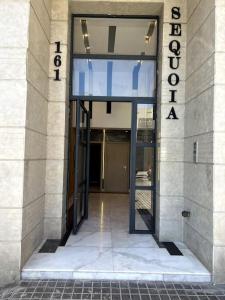 an entrance to a building with a sign on it at Best location, 2 minute to beach in Casablanca