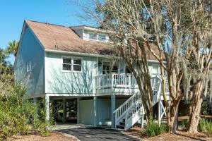 a large house with a porch and a balcony at 507 Tarpon Pond Cottage in Johns Island