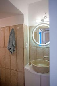 a bathroom with a sink and a mirror at Nice & Cosy Mykonos studios in Megali Ammos