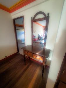 a room with a dressing table and a mirror at Hotel Chasqui del Sol in Copacabana