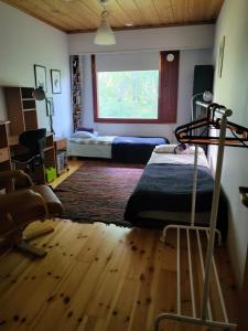 a bedroom with a bed and a window at Villa Maria in Varkaus