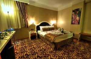 A bed or beds in a room at Golden Deluxe Hotel