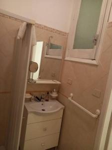 a small bathroom with a sink and a mirror at Taormina spiaggia Casa Sole Mare da Annalisa in Mazzeo +14 photos