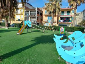 a playground with a slide and a swing at Taormina spiaggia Casa Sole Mare da Annalisa in Mazzeo