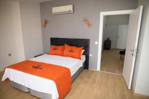 a bedroom with a bed with orange pillows on it at ZOOM HOTEL in Istanbul