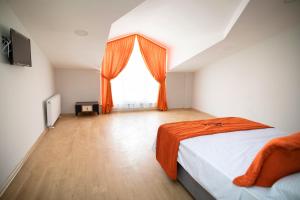 a bedroom with an orange bed and a window at ZOOM HOTEL in Istanbul