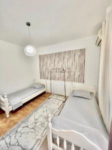 a bedroom with two beds and a window at City center in Ulcinj