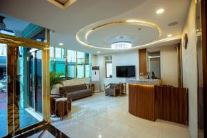 an office lobby with a couch and a table at Apartment 79 Hotel in Ikeja
