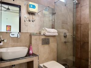 ein Badezimmer mit Toilette, Waschbecken und Dusche in der Unterkunft Lily 3BHK by Wabi Sabi Stays with Private Balcony in Rishikesh + 38 Fotos