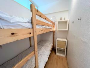 a small room with two bunk beds in it at Panoramic App C02-1 in Sierksdorf +17 photos