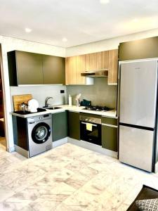 a kitchen with a refrigerator and a washing machine at Best location, 2 minute to beach in Casablanca