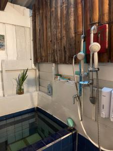 a bathroom with a bath tub with a shower at Gumm Lonely Club in Ko Kood