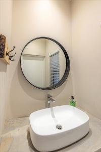 a bathroom with a white sink and a mirror at Fairfax Cottage in Nottingham Road +70 photos
