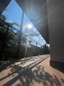 a view of the sun shining through a building at Apusului Residence in Bucharest