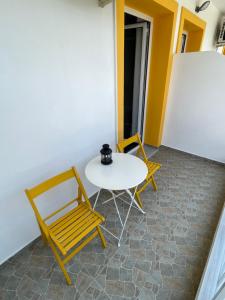 a table and two chairs in a room at Orchard Retreat in Himare