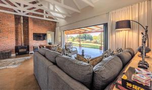 a living room with a couch and a large window at Fairfax Cottage in Nottingham Road