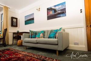 a living room with a couch in a room at Beachside period family home. 5 BR spacious, comfortable. in Dymchurch