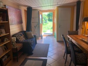 a living room with a blue couch and a table at Domaine Bellevie BnB in Vex