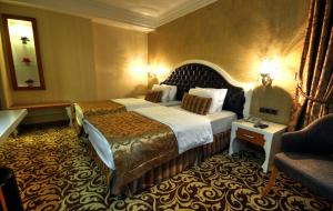 A bed or beds in a room at Golden Deluxe Hotel