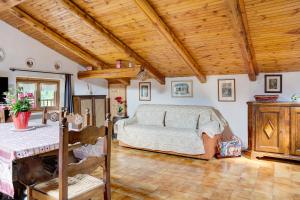 a bedroom with a bed and a table in it at Casa Sasia in Casteldelfino