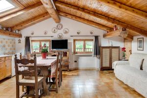 a kitchen and living room with a table and a couch at Casa Sasia in Casteldelfino