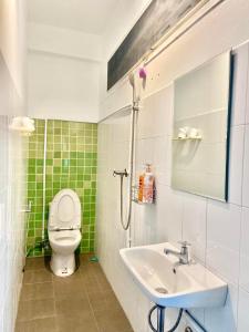 a bathroom with a toilet and a sink at iTalay Krabi in Ban Suan