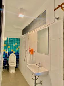 a bathroom with a sink and a toilet at iTalay Krabi in Ban Suan