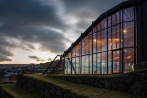 a building with glass windows on the side of it at Atlantic Jewel in Tórshavn