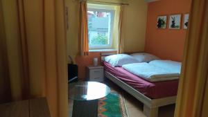 a small bedroom with a bed and a window at Ferienwohnung Kapellenwinkel in Freiburg im Breisgau