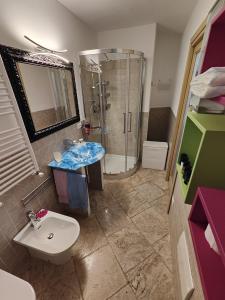 a bathroom with a shower and a sink and a toilet at Villa Alberto in Olbia