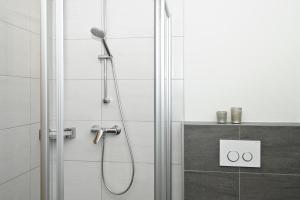 a shower with a shower head in a bathroom at Gasthaus Bacher in Sankt Johann im Pongau