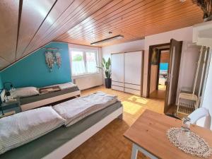 a bedroom with a bed and a blue wall at Ferienwohnung Waldengel in Bad Abbach