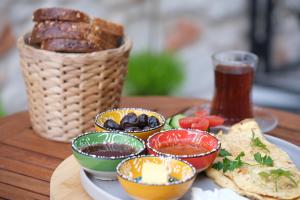 a table with a plate of food and a basket of bread at Wolf Suites in Antalya