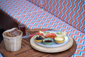 a table with a plate of food and a drink at Wolf Suites in Antalya