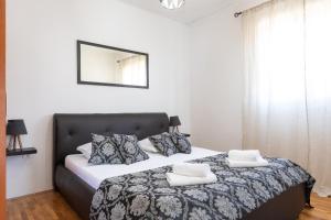 a bedroom with a bed with two pillows on it at Apartments Triporte in Vela Luka