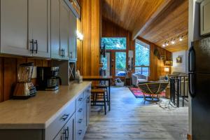 a kitchen with white cabinets and a dining room at Escape To Ptarmigan Village 82 in Whitefish