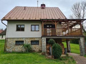 une maison entourée d'une terrasse couverte et d'une terrasse dans l'établissement Chalupa Zvičina, 