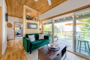 a living room with a green couch and a table at The River View House in Gold Beach