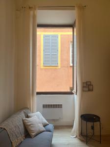 a living room with a window and a couch at Citadelle de Bastia in Bastia