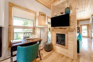 a living room with a desk and a fireplace at The River View House in Gold Beach