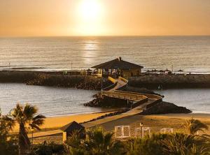 a beach with a staircase leading to the ocean at Casa Mae in Caleta De Fuste
