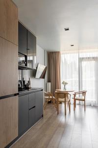 a kitchen with a table and a dining room at WOL 07 by Ribas in Bukovel