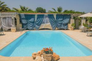 a swimming pool with a teddy bear in the middle at B&B Tenuta Martinelli in Monopoli