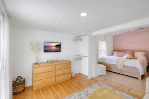 a bedroom with a bed and a wooden dresser at *NEW* The Surf Shack Jupiter! in Tequesta