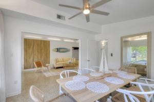 a dining table and chairs in a living room at *NEW* The Surf Shack Jupiter! in Tequesta