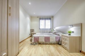 a bedroom with a bed and a dresser and a window at Mestral 1 1 Roses - Immo Barneda in Roses
