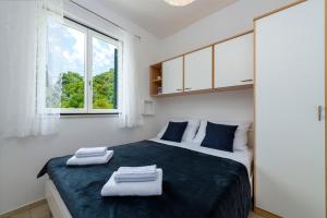 Posteľ alebo postele v izbe v ubytovaní Apartments Mirjana Mljet