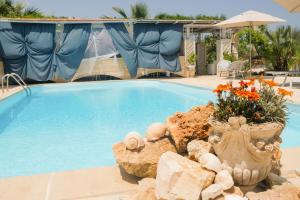 a swimming pool with a large blue pool at B&B Tenuta Martinelli in Monopoli