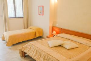a hotel room with two beds and a window at B&B Tenuta Martinelli in Monopoli +37 photos